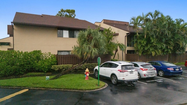 view of vehicle parking featuring a yard