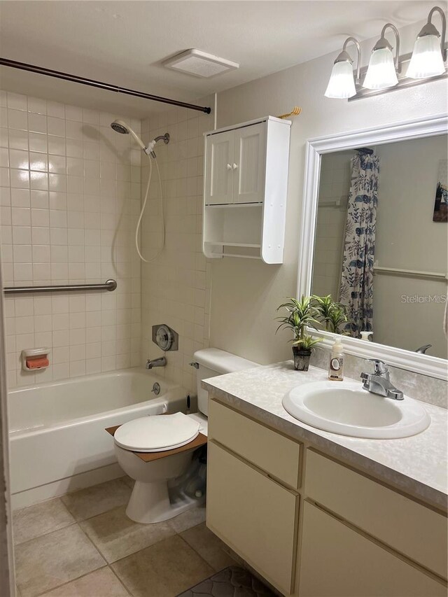 full bathroom featuring vanity, toilet, tile patterned floors, and shower / bath combo with shower curtain