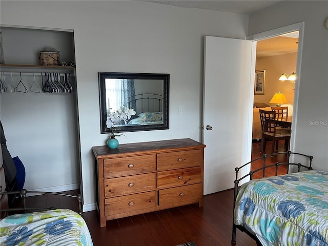 bedroom with dark hardwood / wood-style flooring