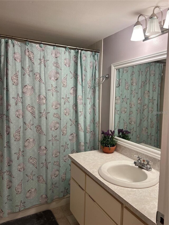 bathroom featuring vanity, tile patterned floors, and walk in shower