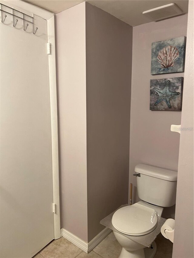 bathroom with tile patterned flooring and toilet