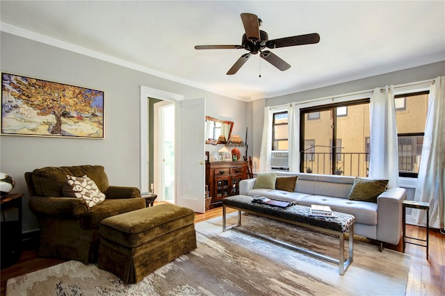 living room with light wood-type flooring, ceiling fan, and crown molding