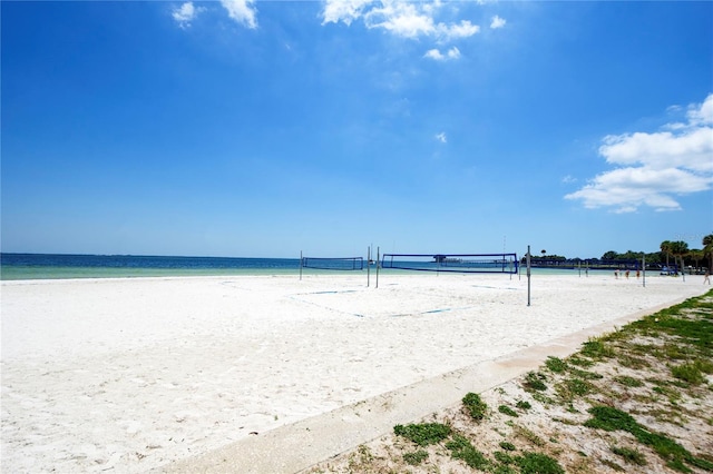 view of property's community with a beach view, a water view, and volleyball court