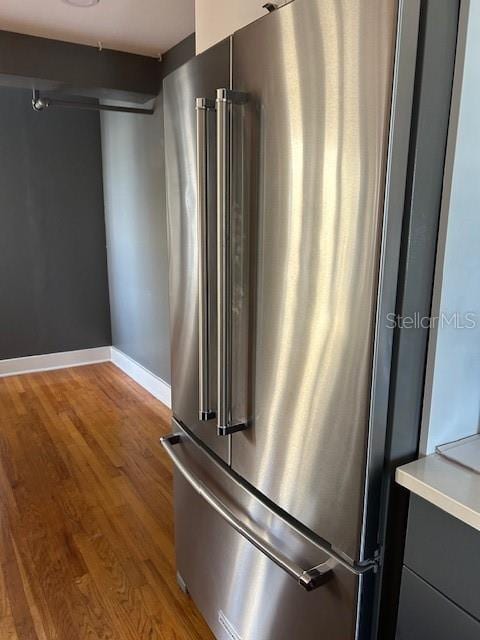 kitchen featuring high end refrigerator and light hardwood / wood-style flooring