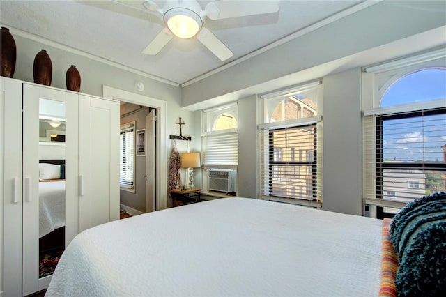 bedroom featuring multiple windows, ceiling fan, and cooling unit