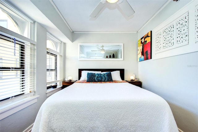 bedroom with ceiling fan and crown molding