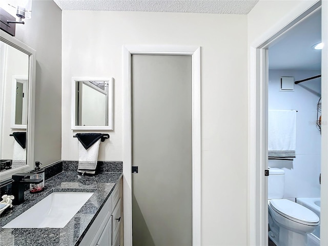 full bathroom featuring shower / bathtub combination, toilet, a textured ceiling, and vanity