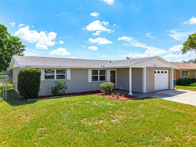 ranch-style home with a garage and a front lawn