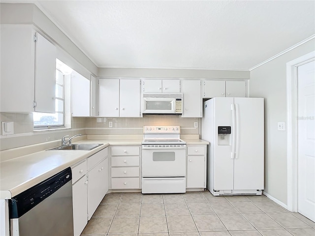 kitchen featuring white cabinets, white appliances, sink, and light tile patterned floors