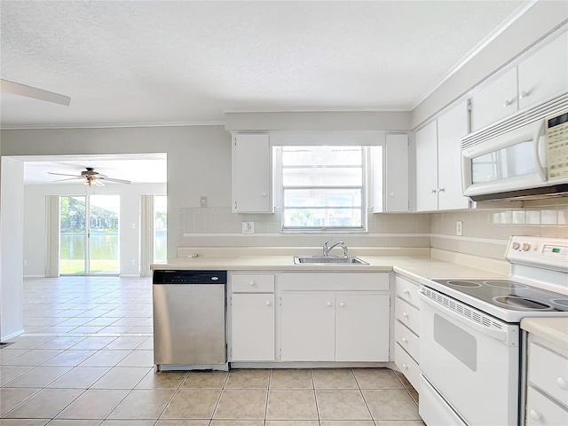 kitchen with sink, light tile patterned floors, white appliances, decorative backsplash, and white cabinets