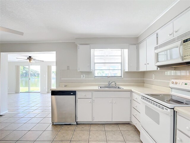 kitchen with white appliances, decorative backsplash, light countertops, a sink, and light tile patterned flooring