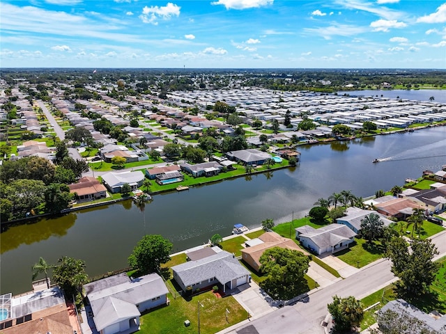 drone / aerial view with a water view and a residential view