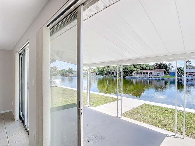 unfurnished sunroom with a water view