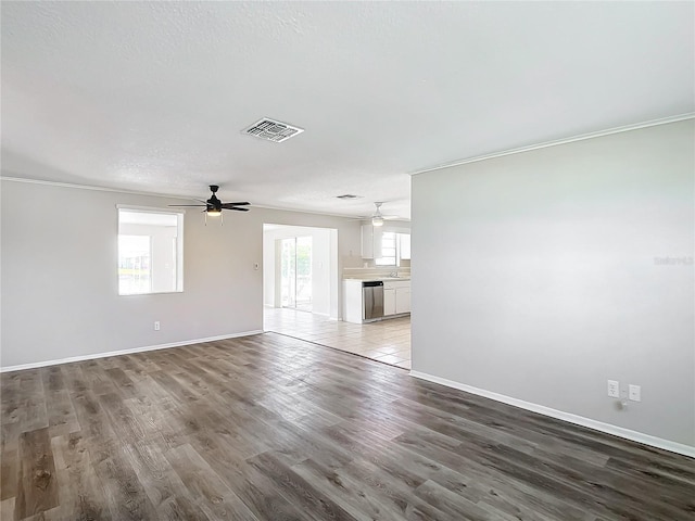 unfurnished living room featuring crown molding, a textured ceiling, and hardwood / wood-style flooring