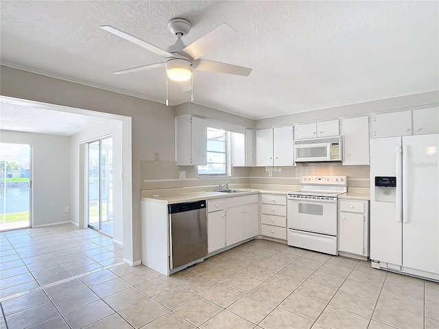 kitchen featuring decorative backsplash, white appliances, white cabinetry, and ceiling fan