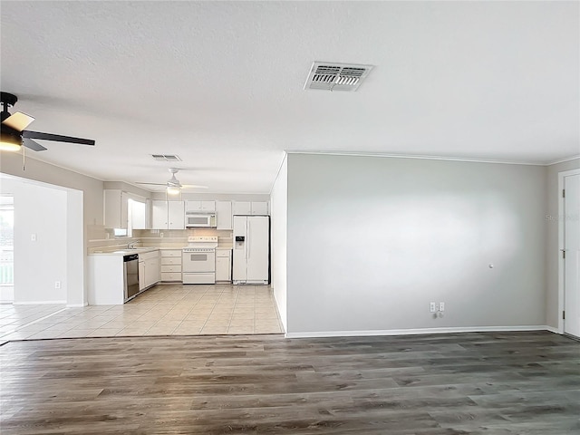 kitchen with ceiling fan, light hardwood / wood-style floors, white appliances, white cabinets, and ornamental molding