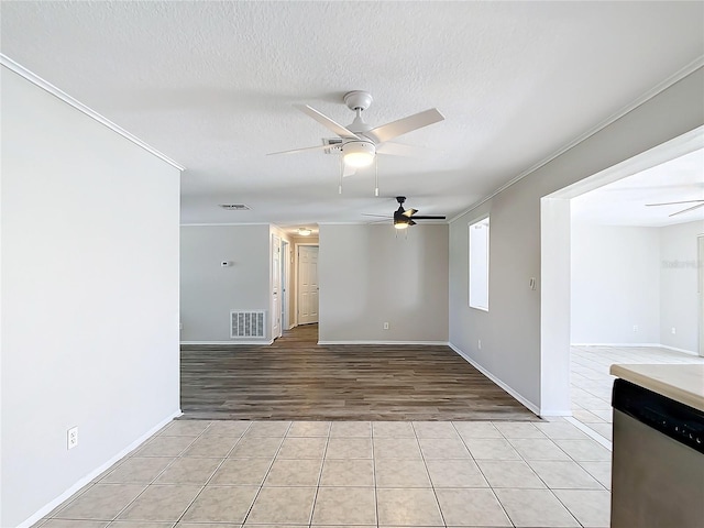 spare room with ceiling fan, light hardwood / wood-style floors, a textured ceiling, and ornamental molding