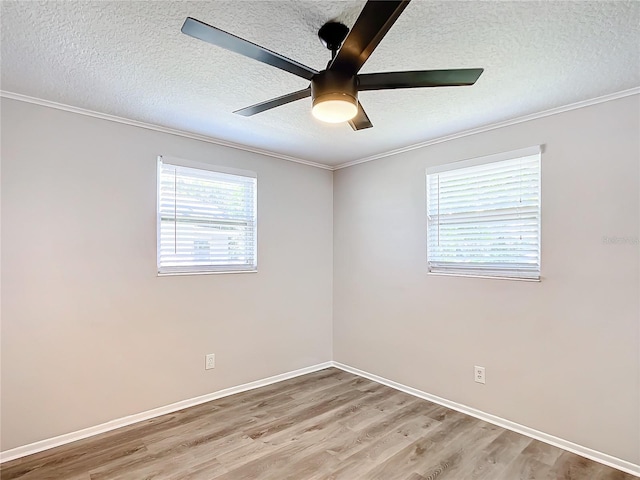 spare room featuring ceiling fan, crown molding, light wood-type flooring, and a textured ceiling