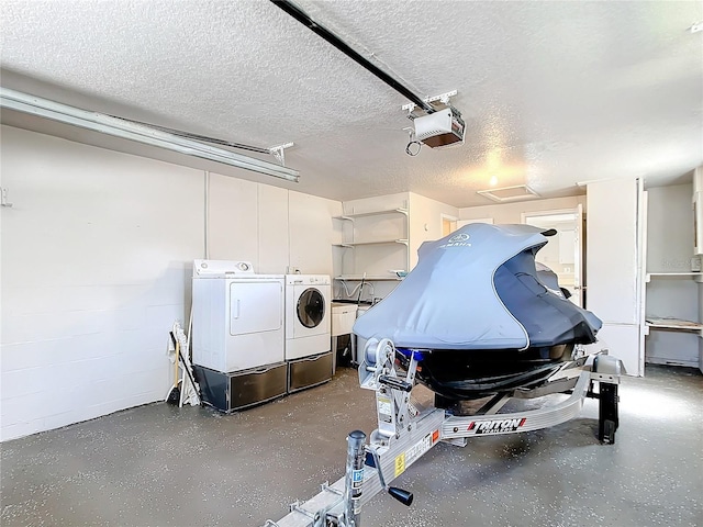 garage with washer and clothes dryer and a garage door opener