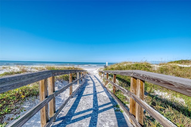 surrounding community featuring a water view and a view of the beach