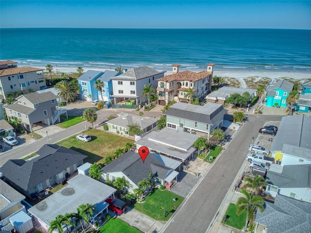 birds eye view of property featuring a residential view, a beach view, and a water view