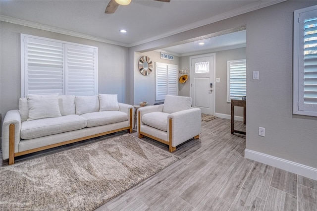 living room featuring crown molding, ceiling fan, baseboards, light wood-type flooring, and recessed lighting