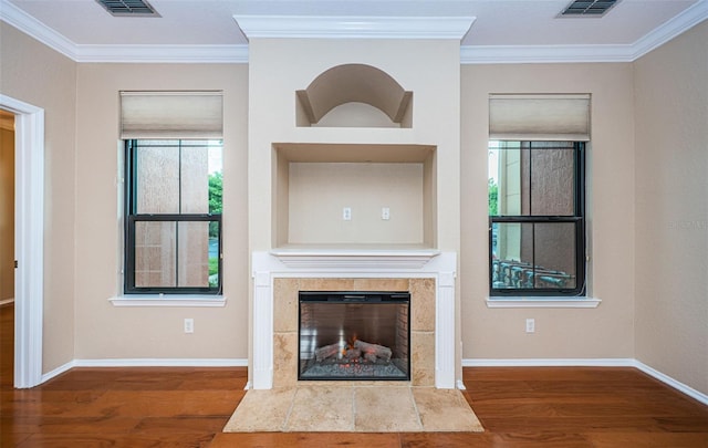 unfurnished living room featuring ornamental molding and hardwood / wood-style flooring