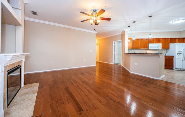 unfurnished living room with crown molding, dark hardwood / wood-style floors, and ceiling fan