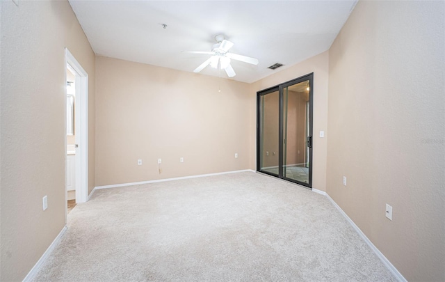 unfurnished room featuring light carpet and ceiling fan