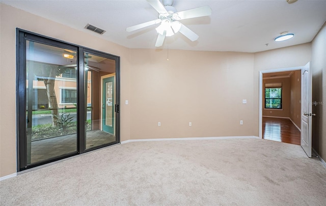 carpeted empty room with ceiling fan