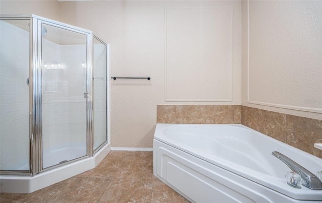 bathroom featuring tile patterned floors and shower with separate bathtub