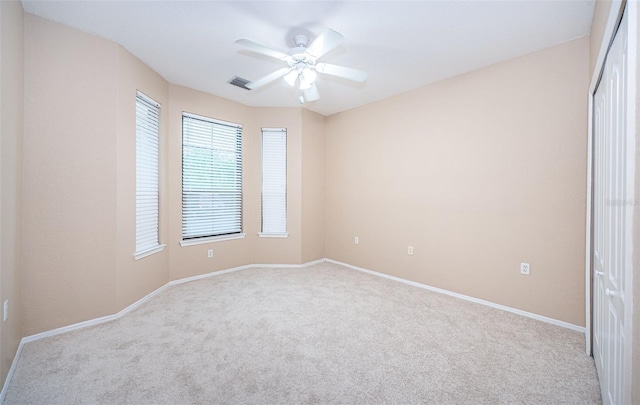 spare room with light carpet and ceiling fan