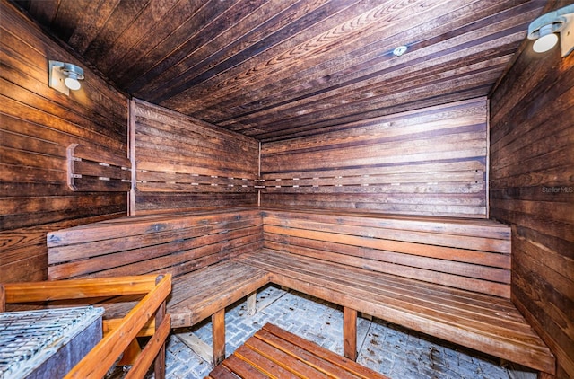 view of sauna / steam room featuring wooden walls and wooden ceiling