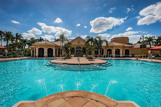 view of pool with pool water feature and a patio