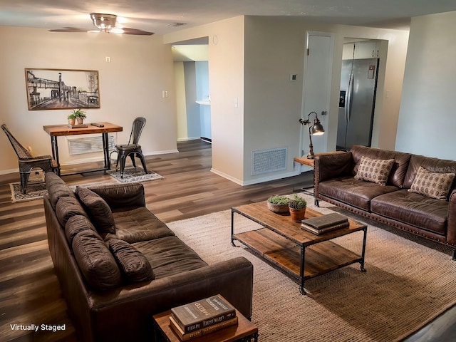 living room featuring wood-type flooring and ceiling fan