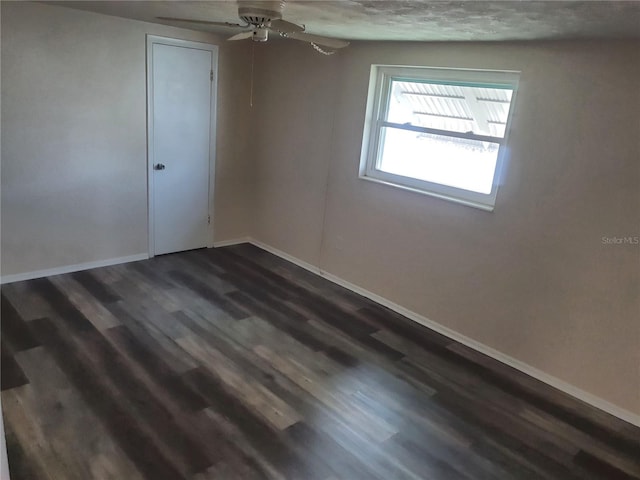 unfurnished room with dark hardwood / wood-style flooring and ceiling fan