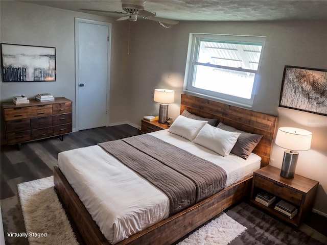 bedroom featuring dark hardwood / wood-style floors and ceiling fan