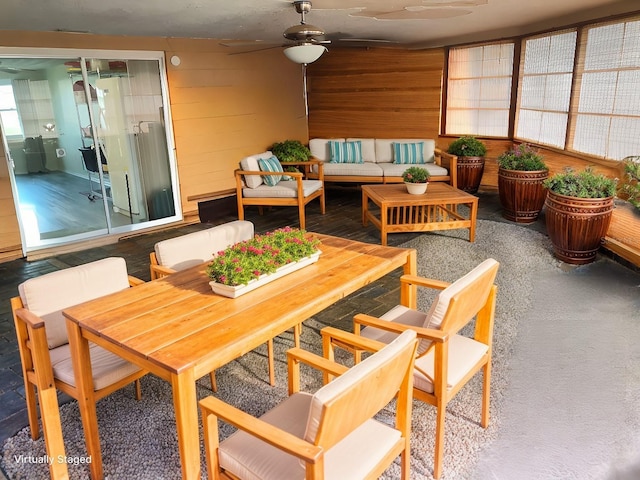 sunroom featuring ceiling fan