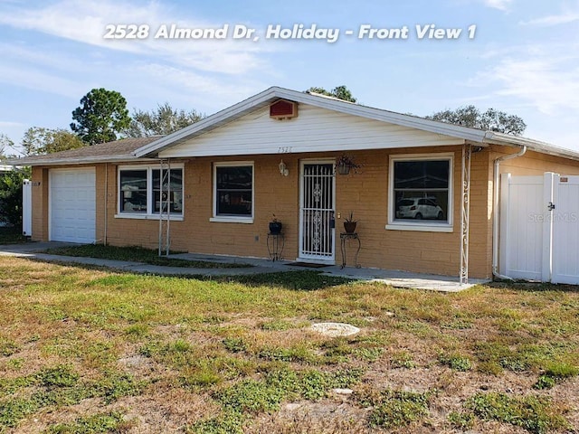 ranch-style home with a garage and a front lawn