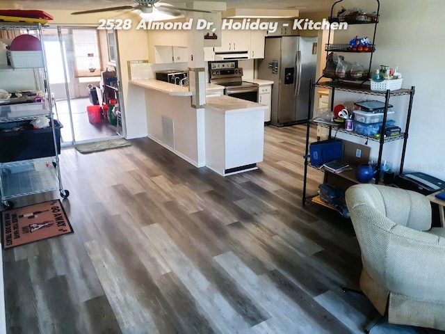 kitchen featuring white cabinetry, appliances with stainless steel finishes, kitchen peninsula, ceiling fan, and hardwood / wood-style floors