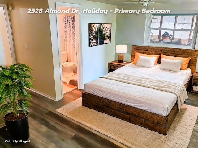 bedroom featuring connected bathroom and dark hardwood / wood-style floors