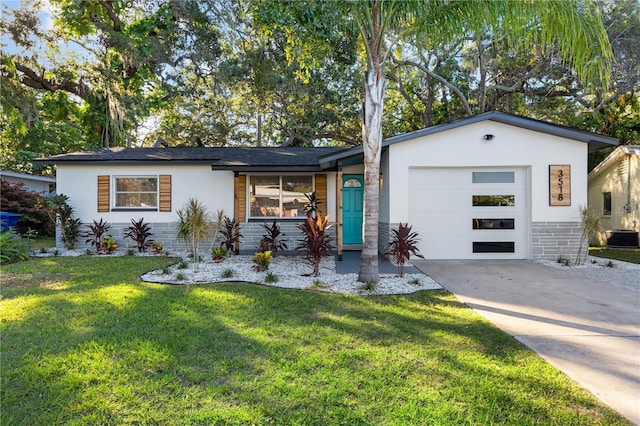 single story home with a garage and a front yard