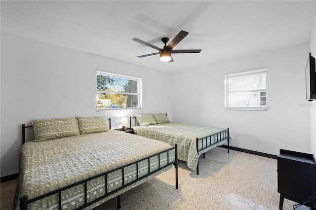 bedroom featuring a textured ceiling and ceiling fan