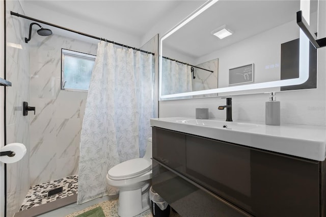 bathroom featuring a shower with shower curtain, toilet, and vanity