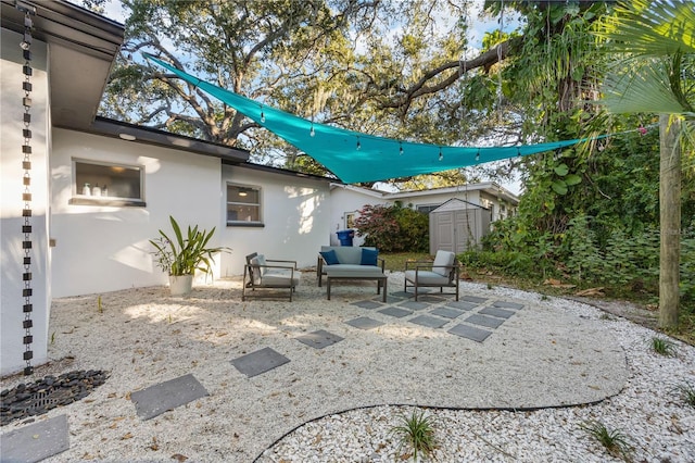 view of patio / terrace featuring an outdoor hangout area and a shed