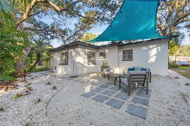 back of property with a patio area and outdoor lounge area