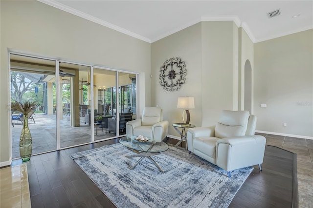 living room with ornamental molding and hardwood / wood-style floors