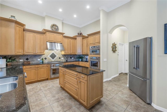 kitchen featuring tasteful backsplash, crown molding, stainless steel appliances, dark stone countertops, and light tile patterned flooring