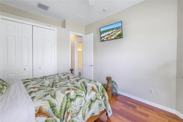 bedroom with ceiling fan, hardwood / wood-style floors, and a closet