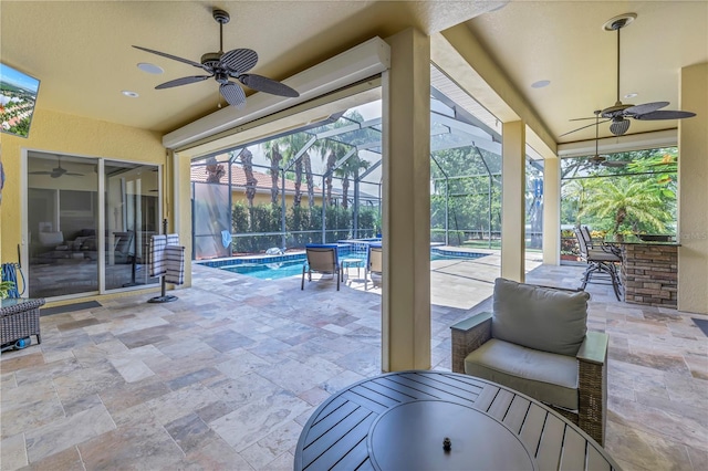 view of patio with ceiling fan, a lanai, and a bar